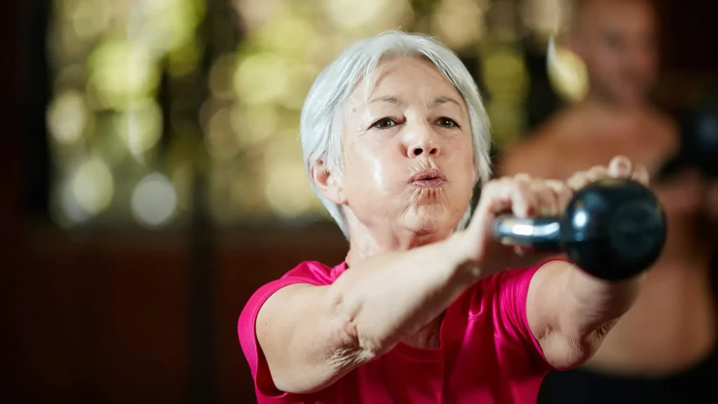 Toning Arms Without the Bulk: Is It Achievable? 1 Woman doing resistance band exercises for toned arms Hertfordshire